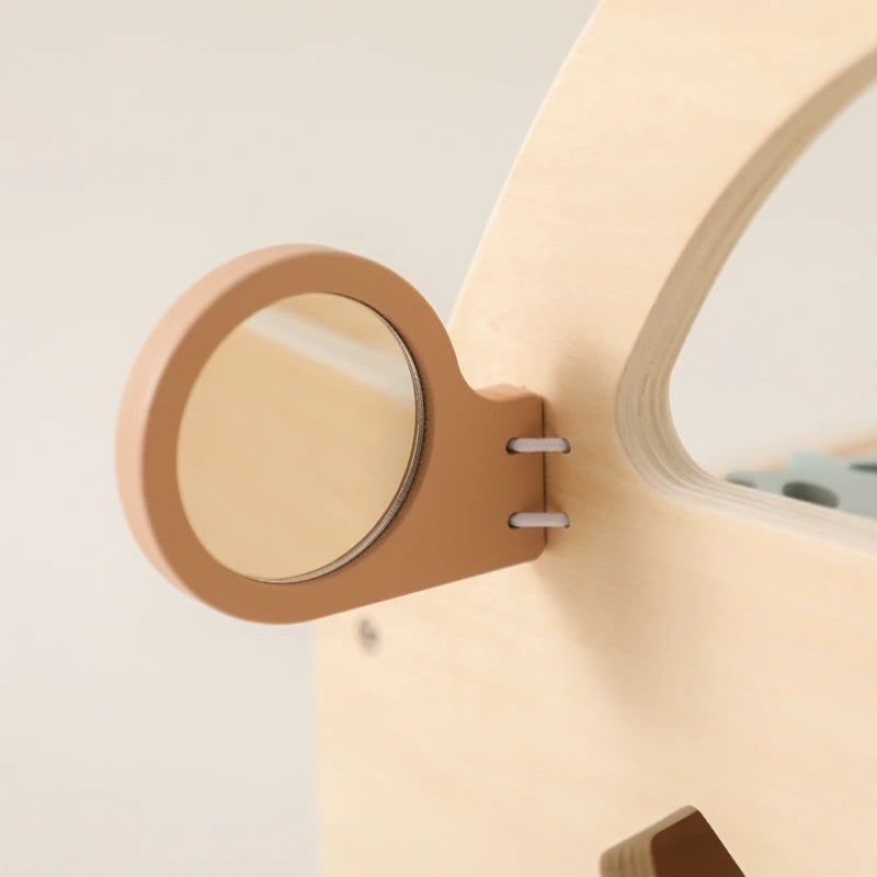 Close-up of the round mirror on the side of the wooden walker