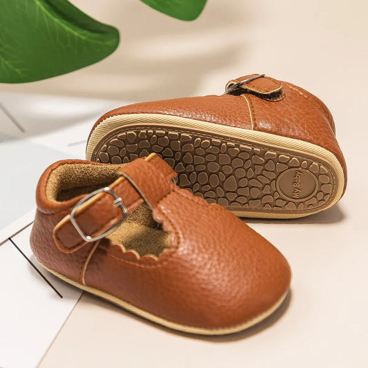 Bubebaby BabyLove faux leather dress shoes in a classic look. The shoes feature a sleek, polished design perfect for special occasions or formal wear. With a soft, cushioned interior for comfort
