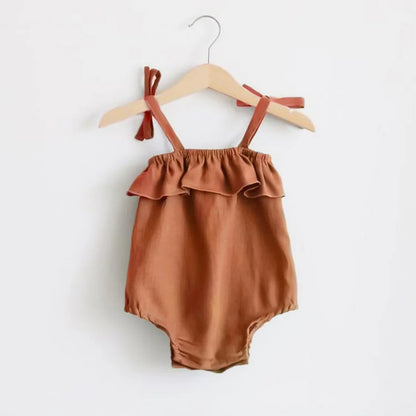 Shop the BabyLove Summer Romper at BubeBaby! A sleeveless, solid-colored romper with a ruffled bust . Made from 100% cotton, it's available for ages 0-24 months. Fits true to size and is perfect for summer. Choose the right size based on age and measurements for a comfortable fit