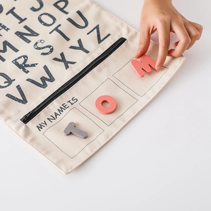 Child placing felt letters into the My Name Is strip to spell TOM