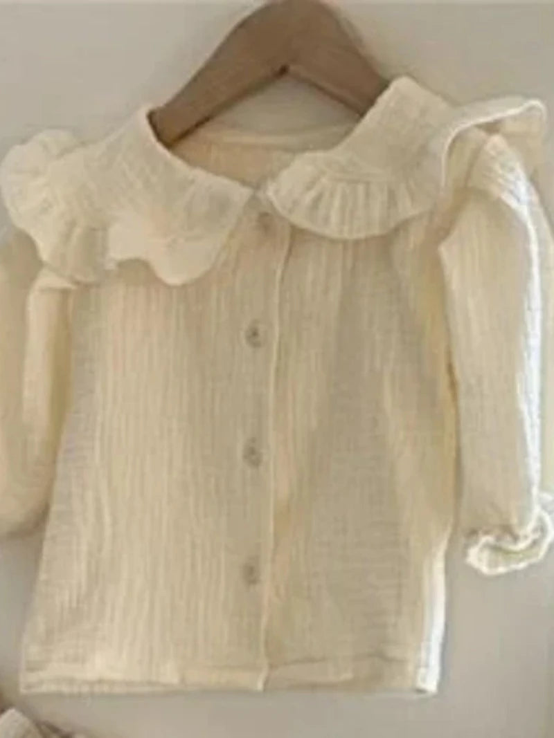 BabyLove by Bubebaby muslin/cotton full sleeve shirt in soft colors with a farm style feel. The shirt features a button-down front, peterpan collar , and gentle gathers at the sleeves for a comfortable fit. Ideal for keeping little ones cozy and stylish