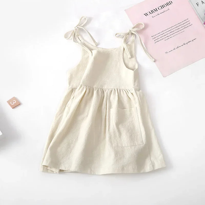 A BabyLove by Bubebaby light and breezy summer dress with spaghetti straps, designed for babies. The dress features a loose, relaxed fit and a soft, comfortable fabric, perfect for keeping little ones cool on warm days