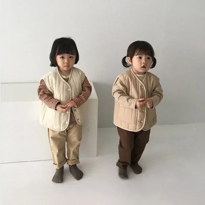 a cozy BabyLove by Bubebaby padded waistcoat, featuring soft, warm fabric and a cute design. Perfect for keeping your little one comfortable and stylish during cooler weather