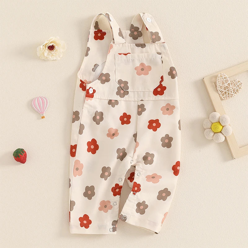 Bubebaby BabyLove Floral Jumpsuit Dungaree Romper. The romper features a floral pattern with a mix of vibrant colors. Featuring a pocket on the chest with shoulder straps, and snap closures at the bottom for easy diaper changes.