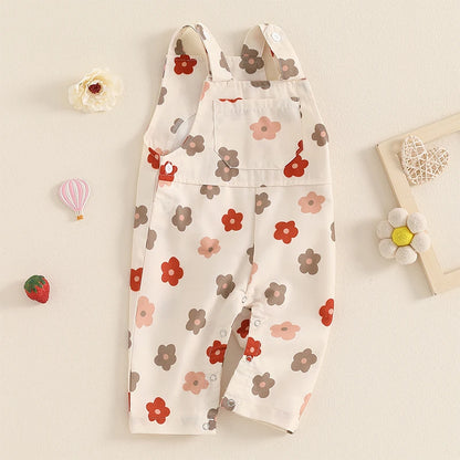 Bubebaby BabyLove Floral Jumpsuit Dungaree Romper. The romper features a floral pattern with a mix of vibrant colors. Featuring a pocket on the chest with shoulder straps, and snap closures at the bottom for easy diaper changes.