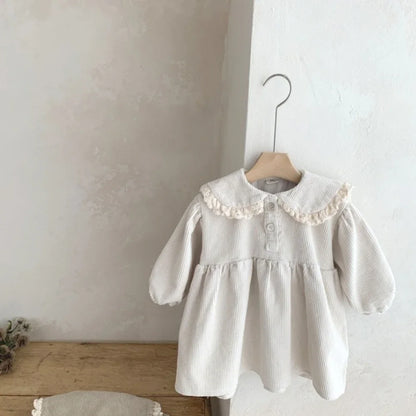 BabyLove Corduroy Peter Pan Collar Dress - A charming baby dress made from soft corduroy fabric, featuring a classic Peter Pan collar and delicate detailing, perfect for special occasions or everyday wear