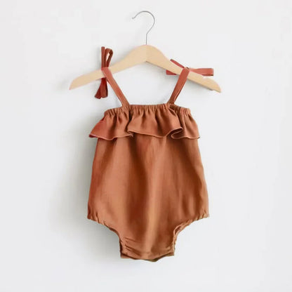 Shop the BabyLove Summer Romper at BubeBaby! A sleeveless, solid-colored romper with a ruffled bust . Made from 100% cotton, it's available for ages 0-24 months. Fits true to size and is perfect for summer. Choose the right size based on age and measurements for a comfortable fit
