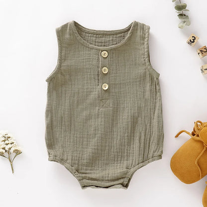 the BabyLove Sleeveless Romper at BubeBaby, designed for babies 0-24 months. Made from soft cotton, this solid-colored romper features an O-neck and covered button closure, perfect for summer