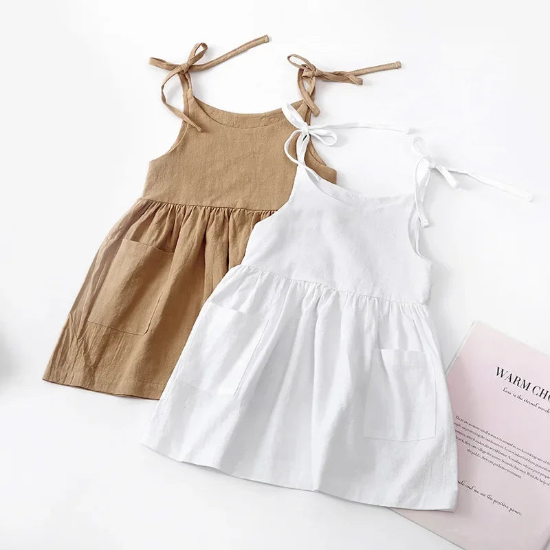 A BabyLove by Bubebaby light and breezy summer dress with spaghetti straps, designed for babies. The dress features a loose, relaxed fit and a soft, comfortable fabric, perfect for keeping little ones cool on warm days