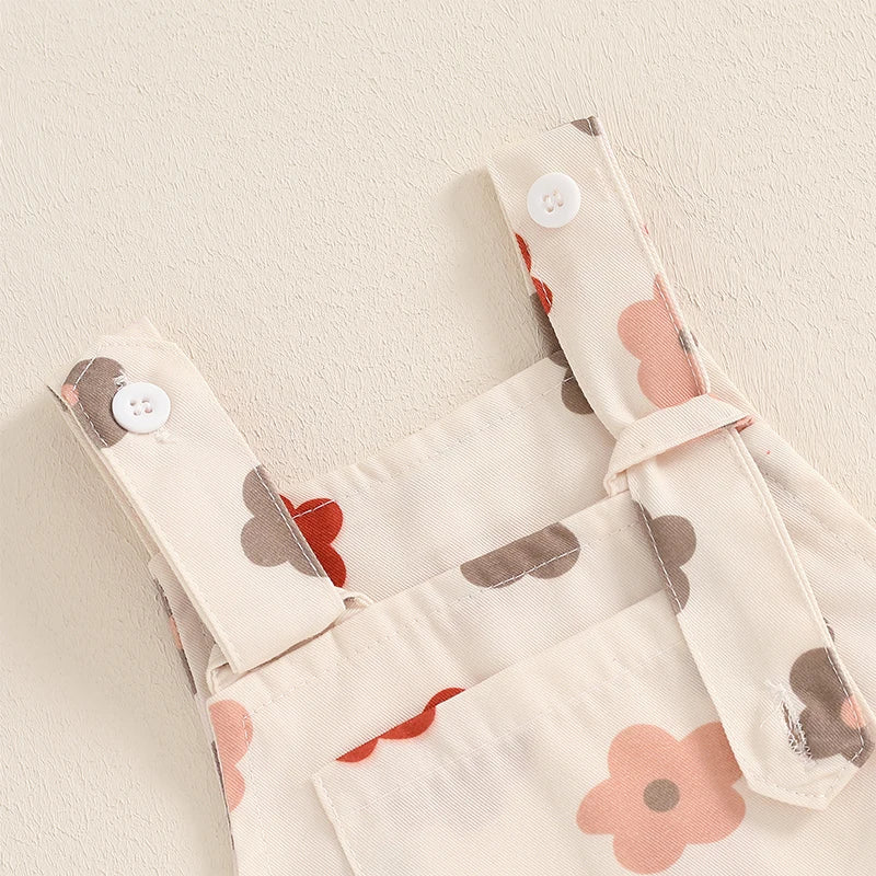 Bubebaby BabyLove Floral Jumpsuit Dungaree Romper. The romper features a floral pattern with a mix of vibrant colors. Featuring a pocket on the chest with shoulder straps, and snap closures at the bottom for easy diaper changes.