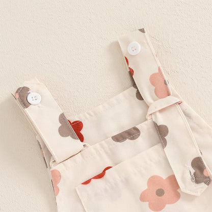 Bubebaby BabyLove Floral Jumpsuit Dungaree Romper. The romper features a floral pattern with a mix of vibrant colors. Featuring a pocket on the chest with shoulder straps, and snap closures at the bottom for easy diaper changes.