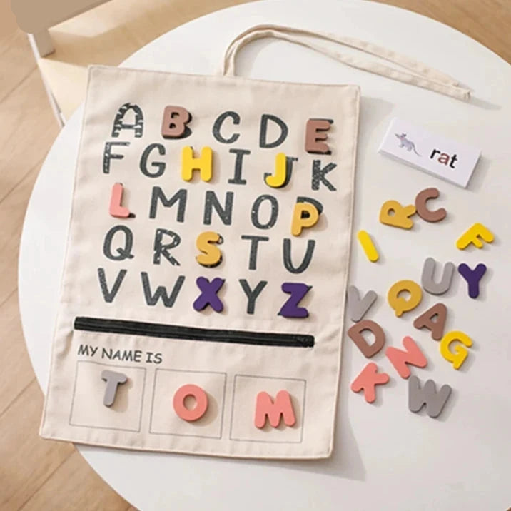 ABC letter canvas board with felt letters, a word card and the name strip spelling TOM