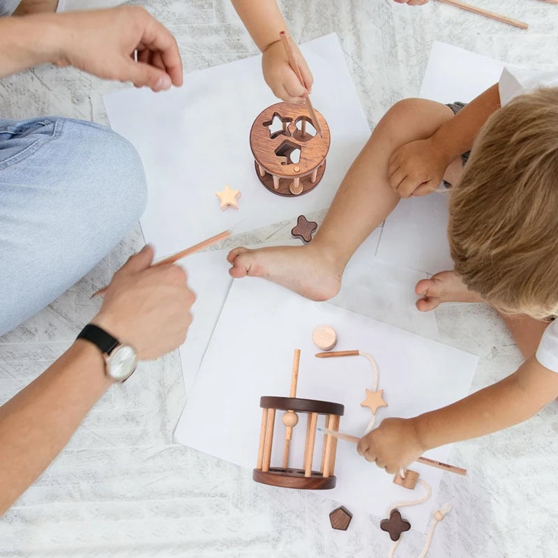 Children playing with wooden shape sorters on the floor