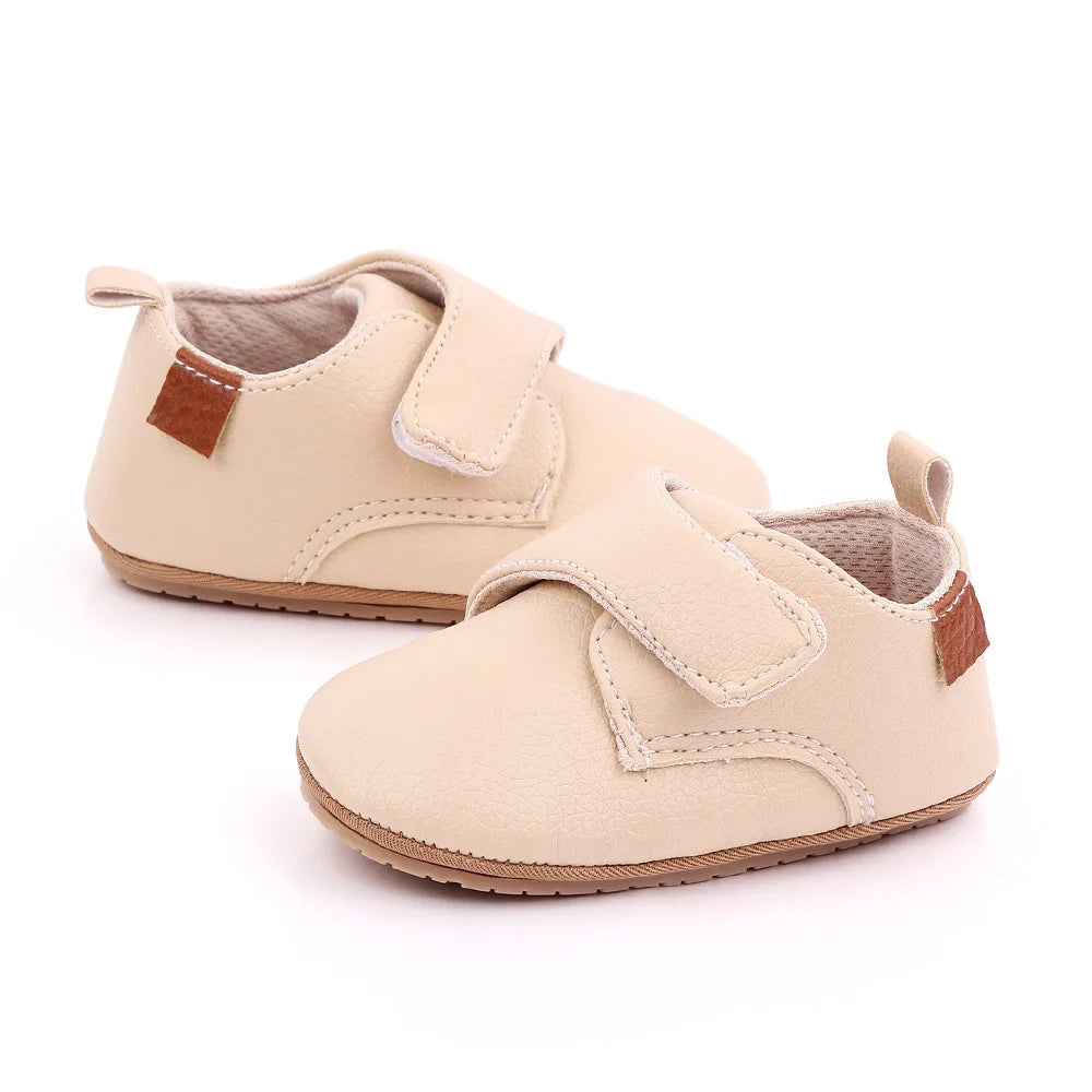 Bubebaby BabyLove faux leather dress shoes in a classic look. The shoes feature a sleek, polished design perfect for special occasions or formal wear. With a soft, cushioned interior for comfort