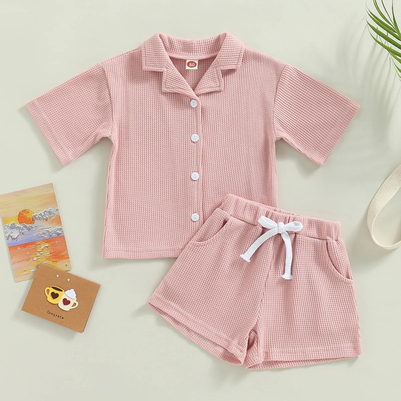 Shop our Bubebaby BabyLove summer baby unisex sets made from cotton and polyester, featuring a V-neck, single-breasted closure, and short sleeves. Available for ages 0-4 years with sizes ranging from 80-120 cm. The set includes a top and shorts with a cute print pattern, fitting true to size. Ideal for warm weather, these sets ensure comfort and style for your little ones.