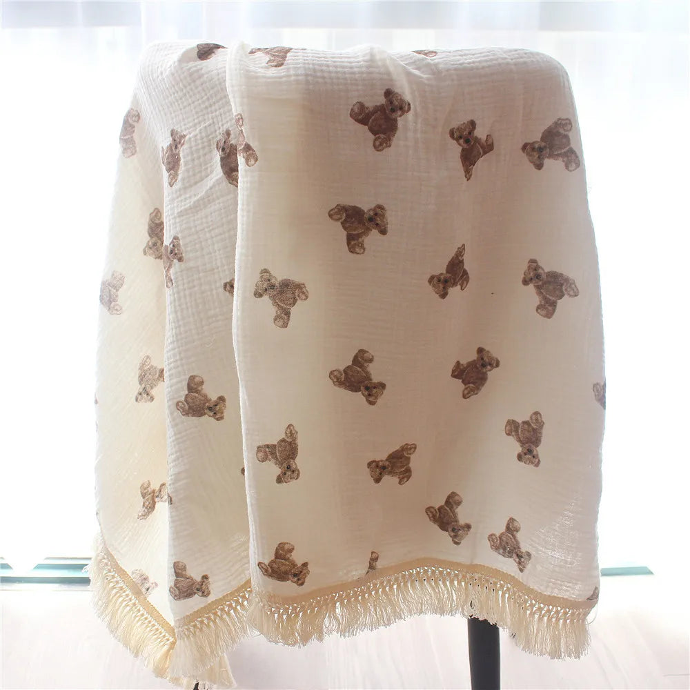 Nursery Muslin Throw Bears at BubeBaby. This unisex throw is made from soft, breathable cotton muslin, perfect for babies. Ideal for snuggling and keeping cozy, it’s designed for comfort and style. Shop now for a versatile, high-quality addition to your nursery essentials