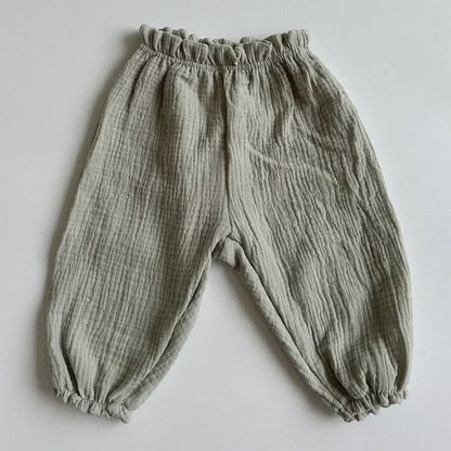 Soft muslin pants for babies from the BabyLove by Bubebaby collection. The pants are made of lightweight, breathable fabric with a gentle, stretchy waistband and a relaxed fit for comfort. The color is a soft, neutral tone, suitable for pairing with various baby tops