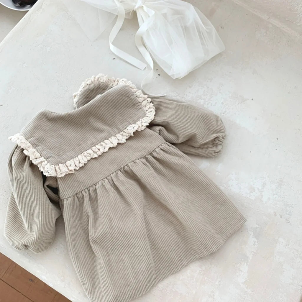 BabyLove Corduroy Peter Pan Collar Dress - A charming baby dress made from soft corduroy fabric, featuring a classic Peter Pan collar and delicate detailing, perfect for special occasions or everyday wear