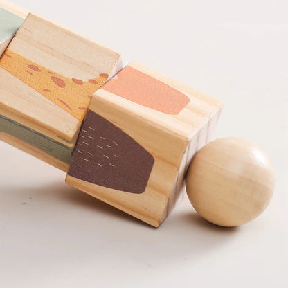 Wooden Montessori Hand Held Rattle, designed for sensory exploration and motor skill development at BubeBaby