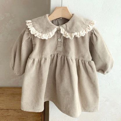 BabyLove Corduroy Peter Pan Collar Dress - A charming baby dress made from soft corduroy fabric, featuring a classic Peter Pan collar and delicate detailing, perfect for special occasions or everyday wear
