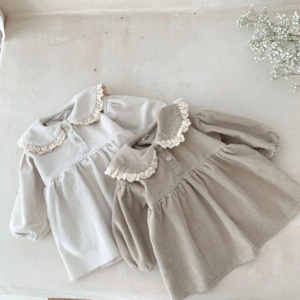 BabyLove Corduroy Peter Pan Collar Dress - A charming baby dress made from soft corduroy fabric, featuring a classic Peter Pan collar and delicate detailing, perfect for special occasions or everyday wear