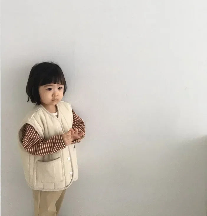 a cozy BabyLove by Bubebaby padded waistcoat, featuring soft, warm fabric and a cute design. Perfect for keeping your little one comfortable and stylish during cooler weather