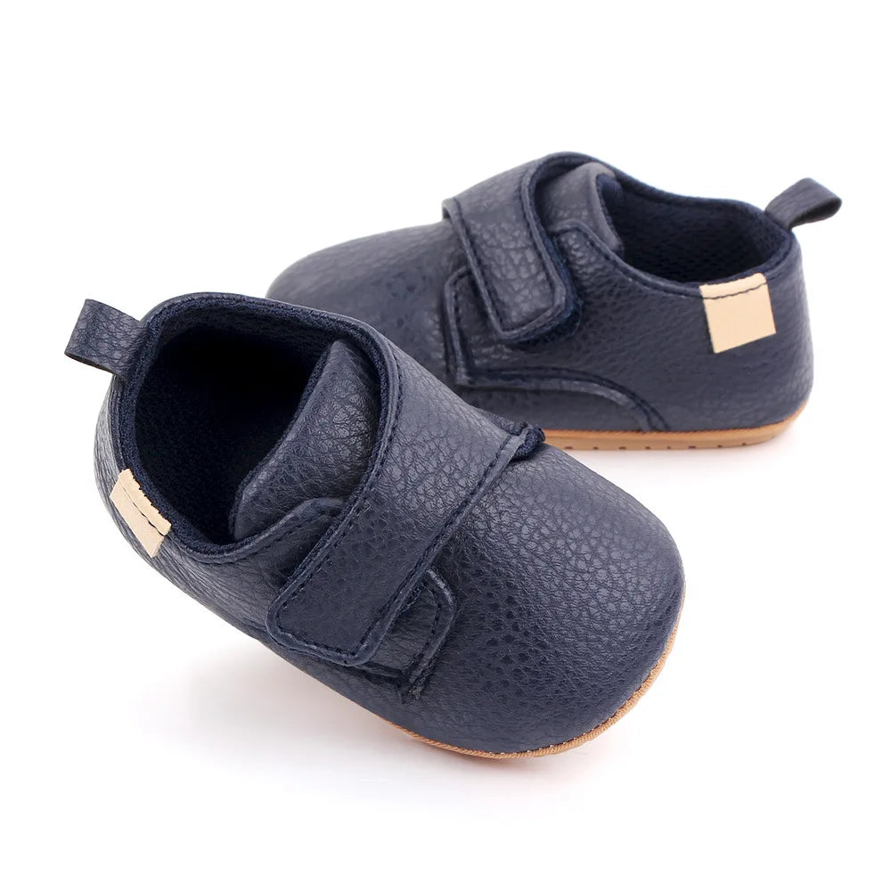 Bubebaby BabyLove faux leather dress shoes in a classic look. The shoes feature a sleek, polished design perfect for special occasions or formal wear. With a soft, cushioned interior for comfort