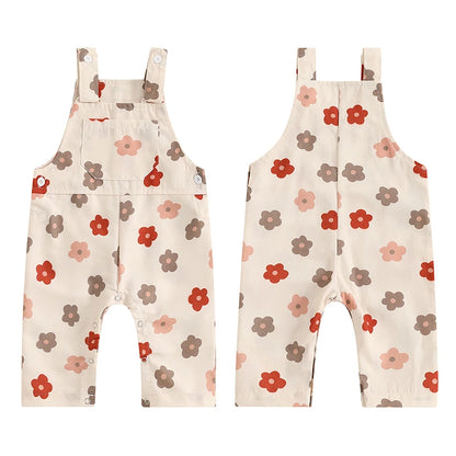 Bubebaby BabyLove Floral Jumpsuit Dungaree Romper. The romper features a floral pattern with a mix of vibrant colors. Featuring a pocket on the chest with shoulder straps, and snap closures at the bottom for easy diaper changes.