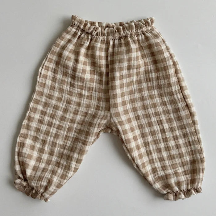 Soft muslin pants for babies from the BabyLove by Bubebaby collection. The pants are made of lightweight, breathable fabric with a gentle, stretchy waistband and a relaxed fit for comfort. The color is a soft, neutral tone, suitable for pairing with various baby tops