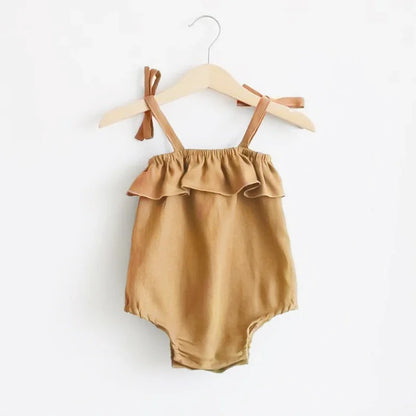 Shop the BabyLove Summer Romper at BubeBaby! A sleeveless, solid-colored romper with a ruffled bust . Made from 100% cotton, it's available for ages 0-24 months. Fits true to size and is perfect for summer. Choose the right size based on age and measurements for a comfortable fit