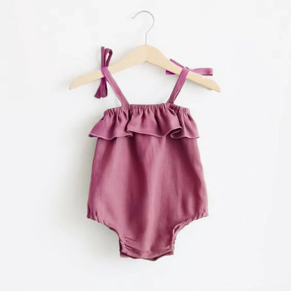 Shop the BabyLove Summer Romper at BubeBaby! A sleeveless, solid-colored romper with a ruffled bust . Made from 100% cotton, it's available for ages 0-24 months. Fits true to size and is perfect for summer. Choose the right size based on age and measurements for a comfortable fit