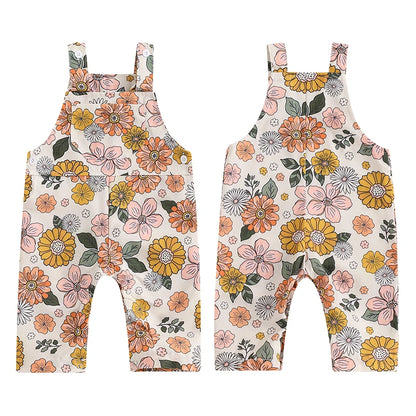 Bubebaby BabyLove Floral Jumpsuit Dungaree Romper. The romper features a floral pattern with a mix of vibrant colors. Featuring a pocket on the chest with shoulder straps, and snap closures at the bottom for easy diaper changes.