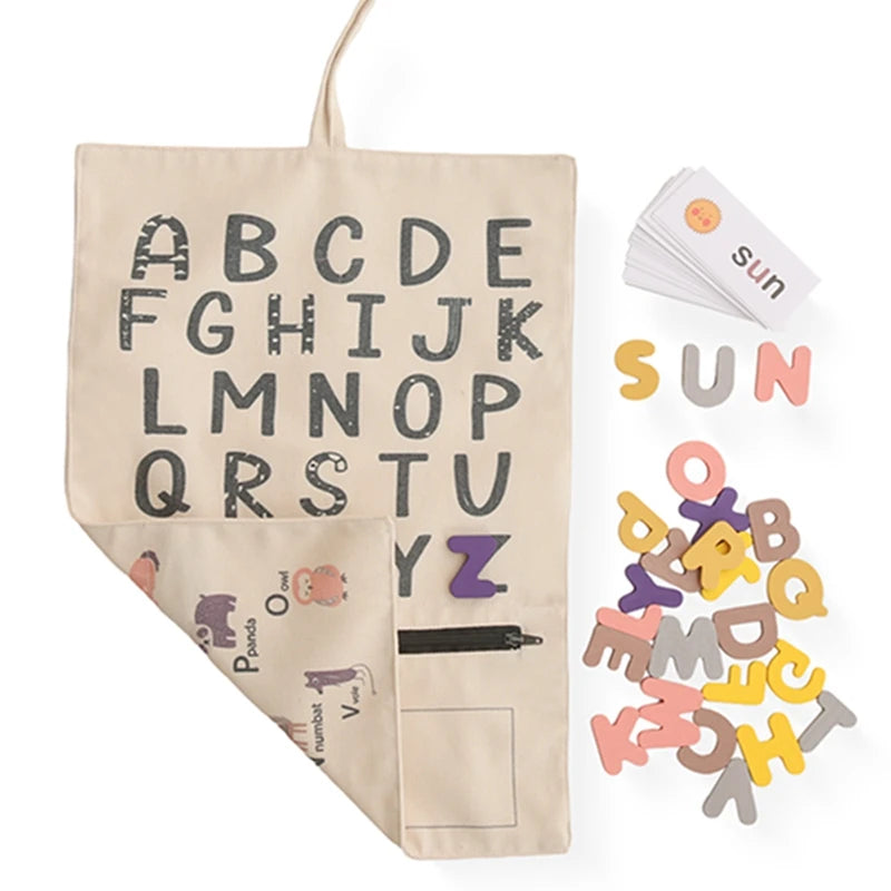 ABC canvas board folded open with felt letters and picture cards spelling SUN