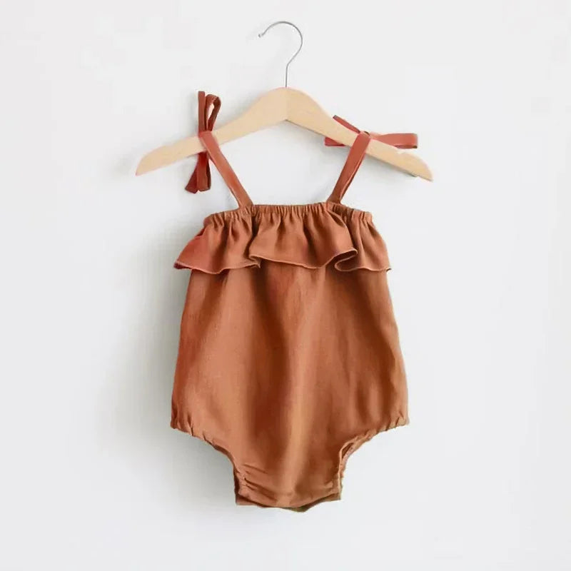 Shop the BabyLove Summer Romper at BubeBaby! A sleeveless, solid-colored romper with a ruffled bust . Made from 100% cotton, it's available for ages 0-24 months. Fits true to size and is perfect for summer. Choose the right size based on age and measurements for a comfortable fit