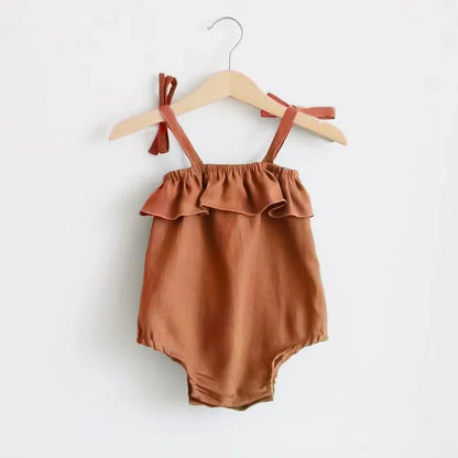 Shop the BabyLove Summer Romper at BubeBaby! A sleeveless, solid-colored romper with a ruffled bust . Made from 100% cotton, it's available for ages 0-24 months. Fits true to size and is perfect for summer. Choose the right size based on age and measurements for a comfortable fit