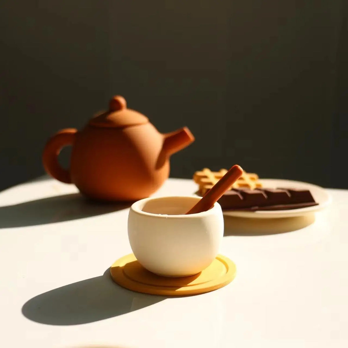 Silicone teapot and teacup with a pretend chocolate bar and waffle