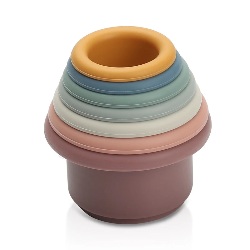 Discover the Montessori Silicone Stacking Cups at BubeBaby. Made from durable ABS, these versatile cups are perfect for beach, bath, and indoor play. Packaged in a net bag, they offer endless fun . Ideal for sensory play and skill development