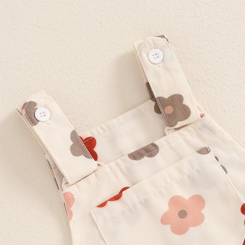 Bubebaby BabyLove Floral Jumpsuit Dungaree Romper. The romper features a floral pattern with a mix of vibrant colors. Featuring a pocket on the chest with shoulder straps, and snap closures at the bottom for easy diaper changes.