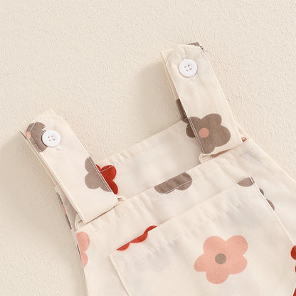 Bubebaby BabyLove Floral Jumpsuit Dungaree Romper. The romper features a floral pattern with a mix of vibrant colors. Featuring a pocket on the chest with shoulder straps, and snap closures at the bottom for easy diaper changes.