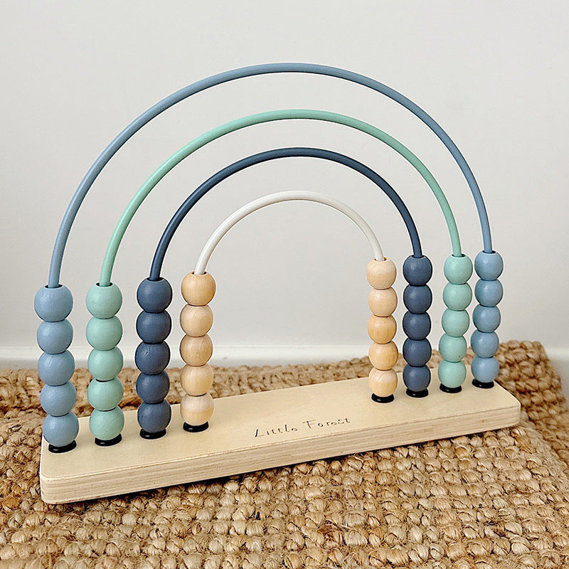Blue wooden rainbow abacus on a woven mat