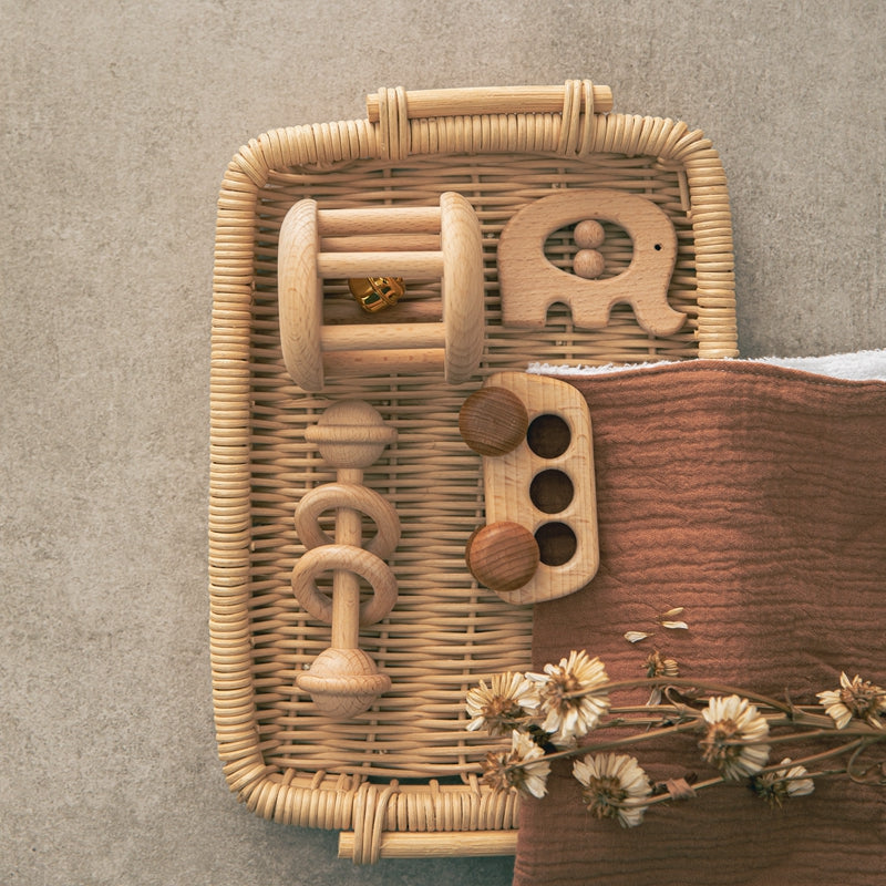 Bus and elephant wooden rattle set on a rattan tray