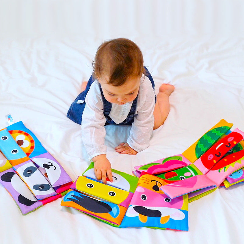 Baby flipping through mix and match cloth books