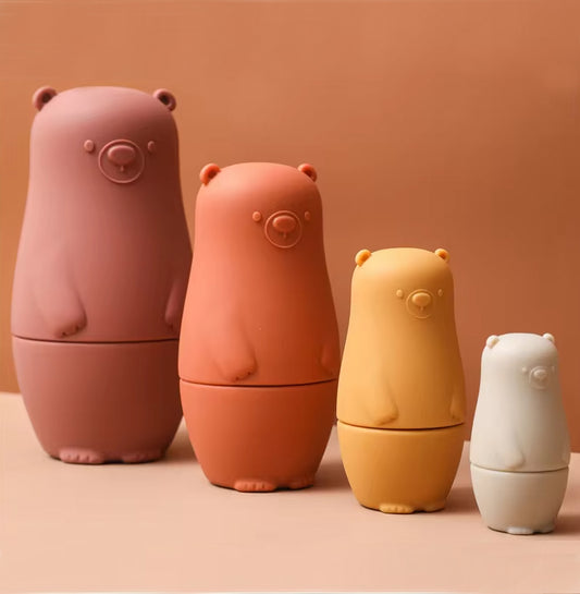 Montessori Silicone Bear Matryoshka Toy: A set of soft, stackable, bear-shaped nesting dolls in various sizes, made from pastel-colored, food-grade silicone. The bears fit inside one another, designed to encourage fine motor skills, sensory exploration, and cognitive development in young children