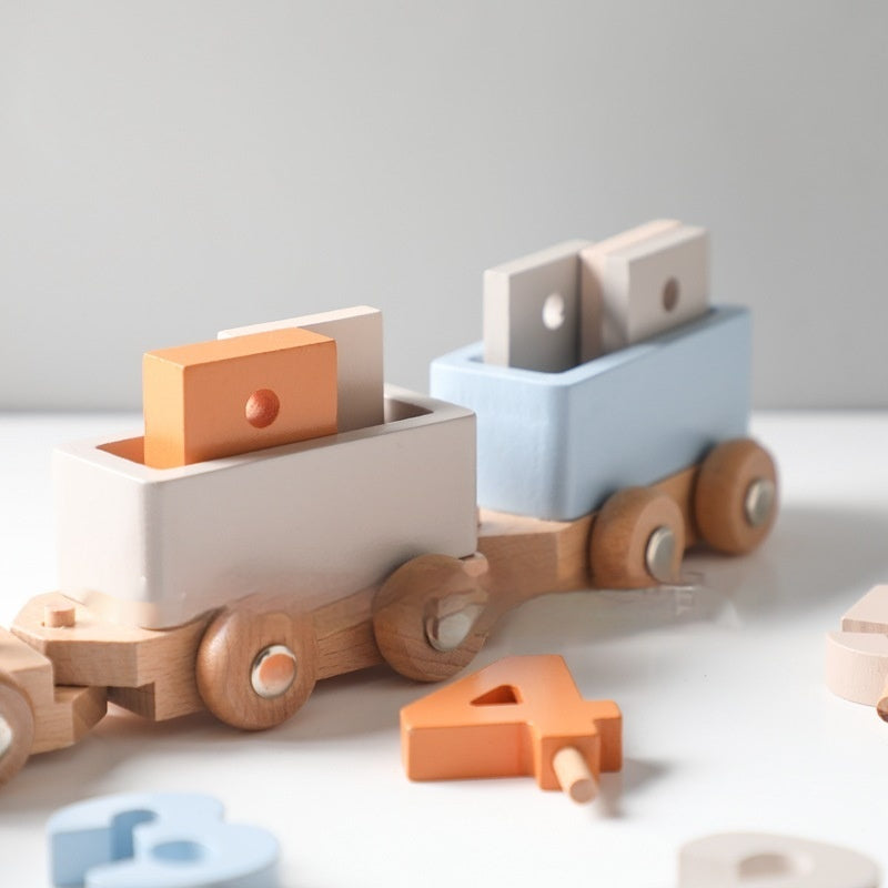 Close-up of wooden train carriages and number pieces