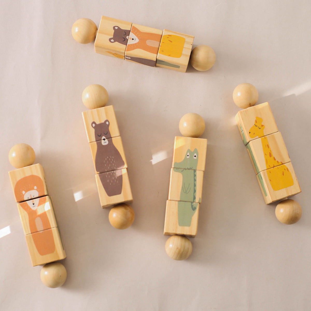 Wooden rotating block puzzles laid out on a table