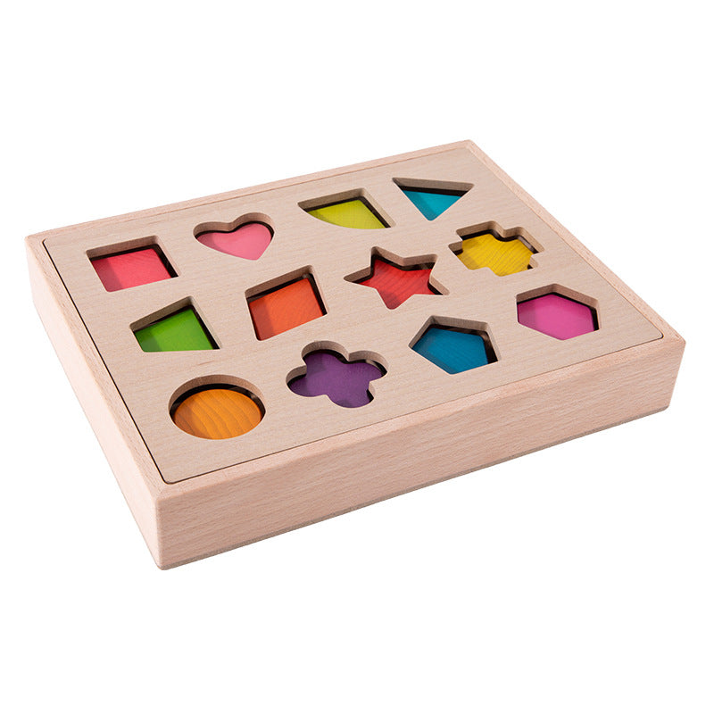 Wooden shape sorting box with colored shapes on white background