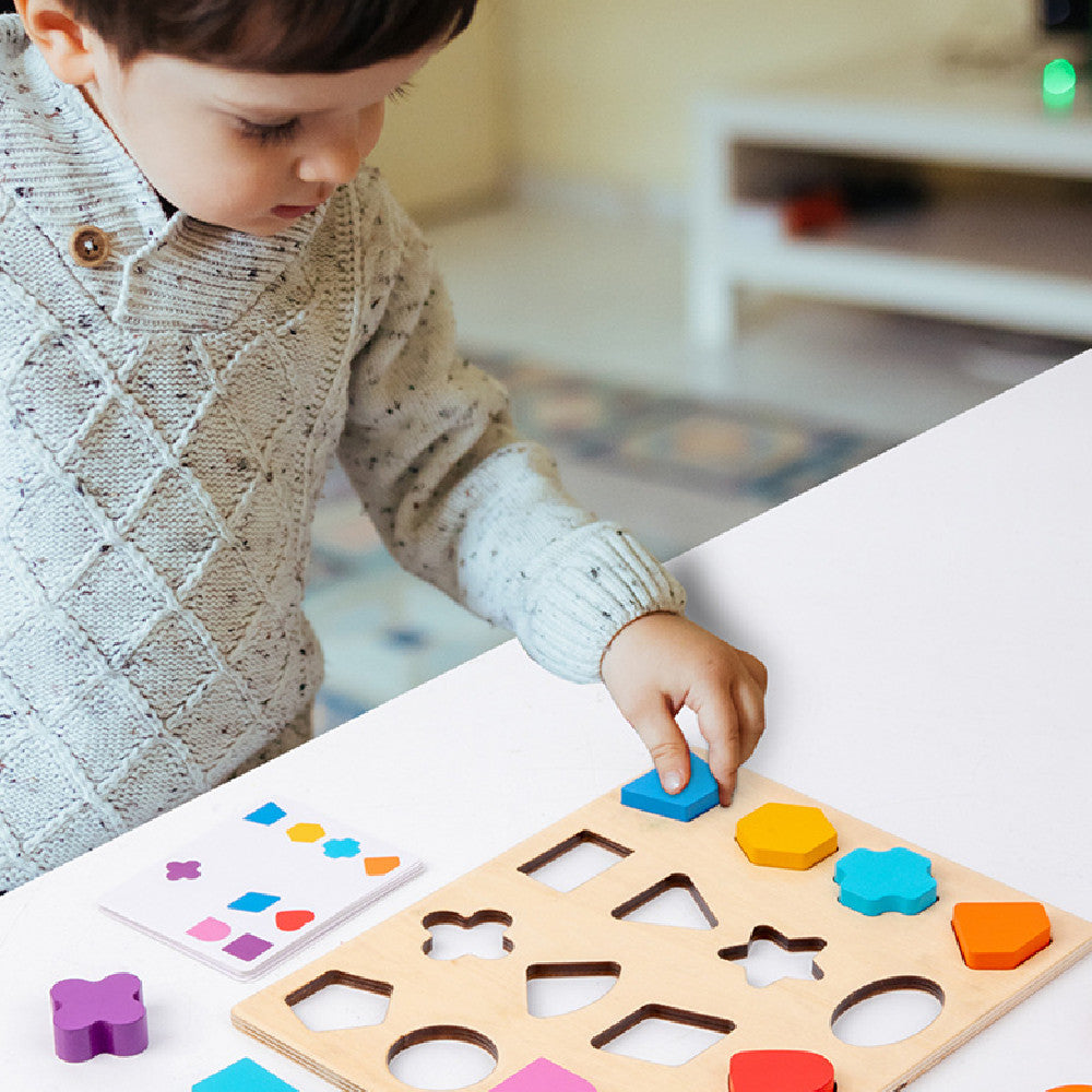 Child playing with a wooden shape sorting board